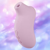 The LELO Sona 3 Cruise in Soft Pink is a curved silicone device with a rounded opening, displayed against a soft pastel purple and blue bokeh background.